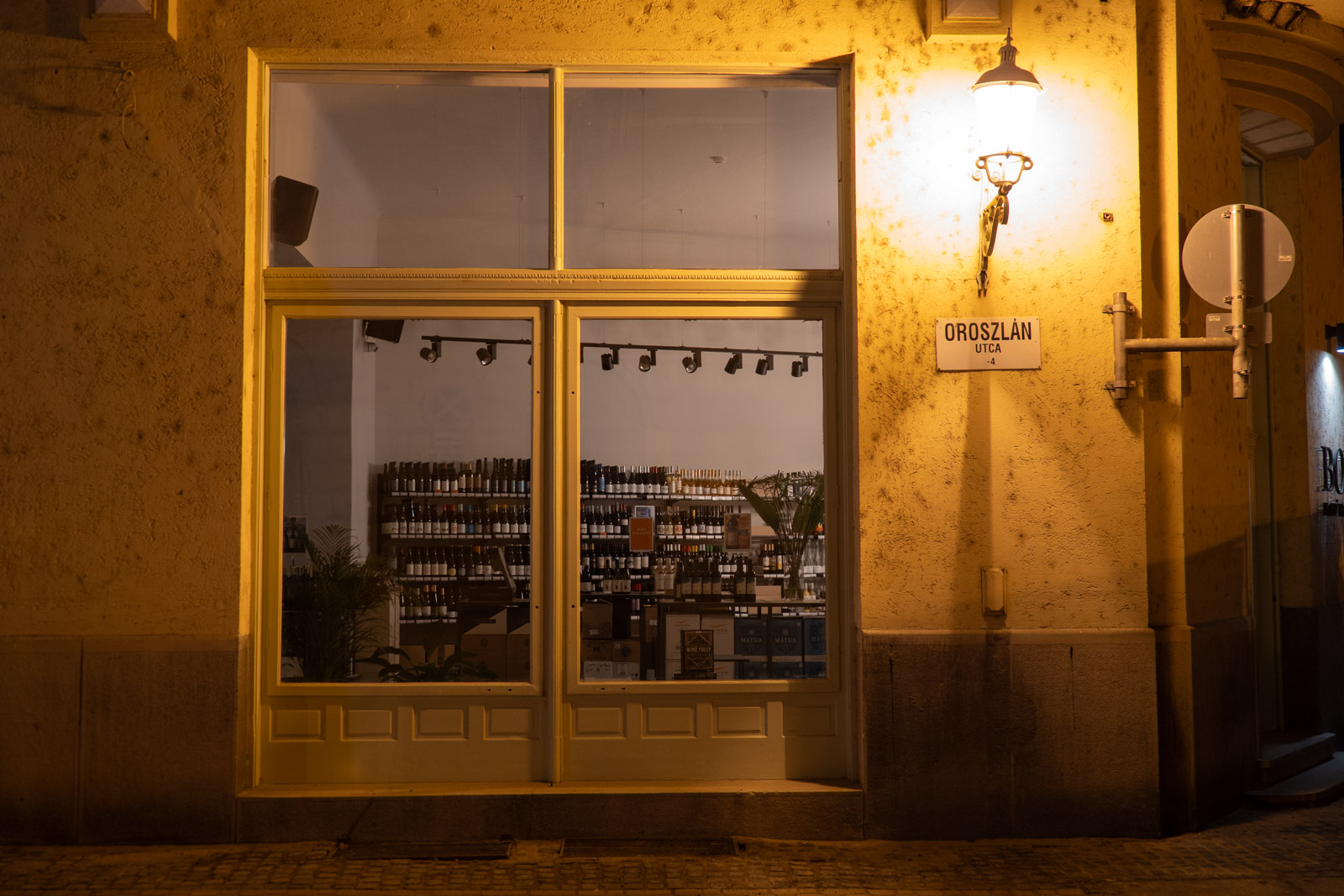 The exterior of a closed wine bar in Szeged, Hungary, on a November evening